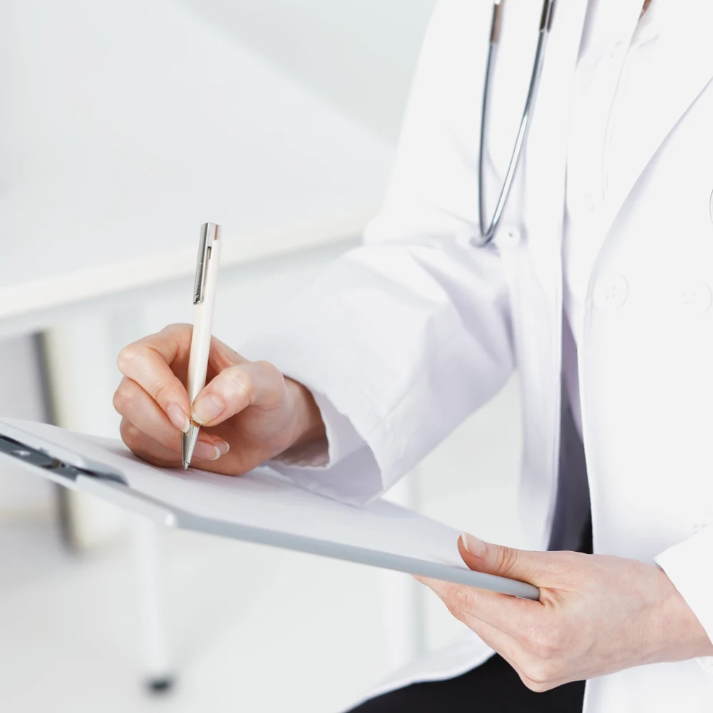 Illustrative close-up of a physician reviewing documentation